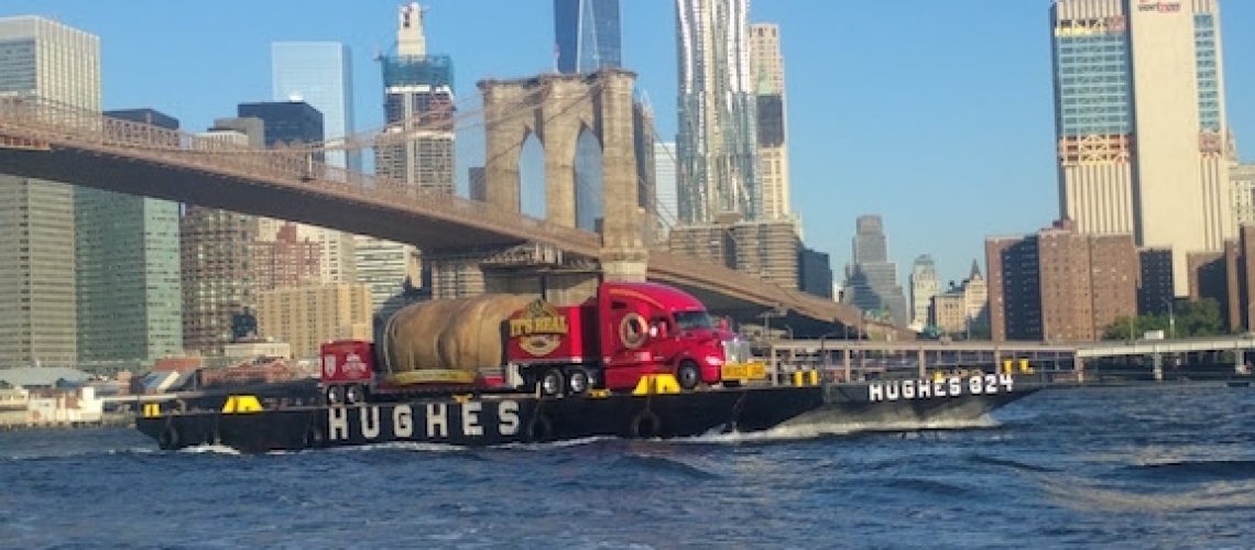 The Big Idaho Potato under the Brooklyn Bridge with WTC 1 in the back ground